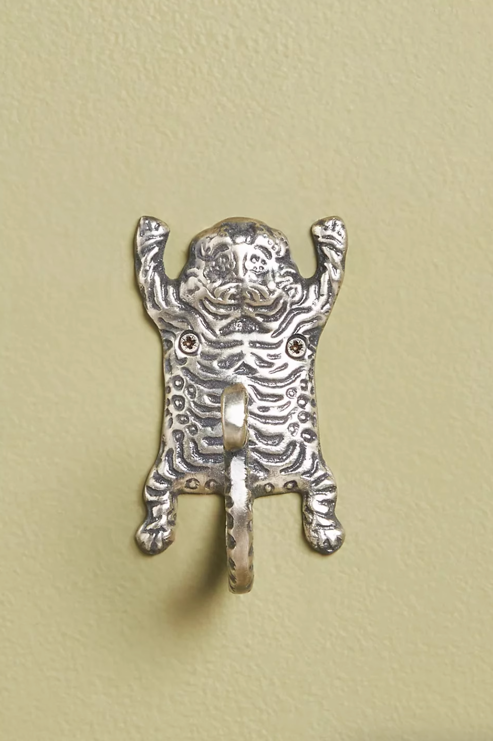 Silver tiger-inspired bathroom hook, part of a home decor set.